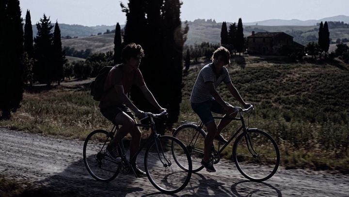 The same shot of two cyclists, graded by AI Color Match to the Contrast City look
