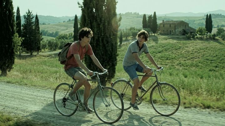 The same shot of two cyclists, graded by AI Color Match to the Green Code look